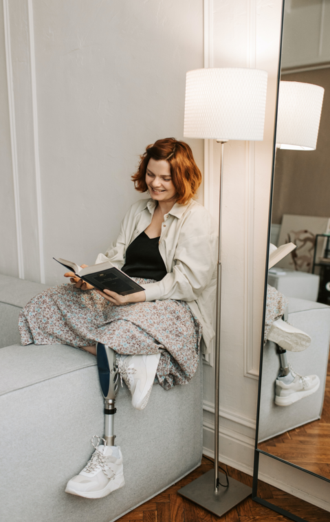 Legal assistance for disabled persons in Los Angeles, woman reading with prosthetic leg