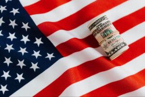 US flag and dollar rolls represent government financial support for different types of disabilities via a competent lawyer