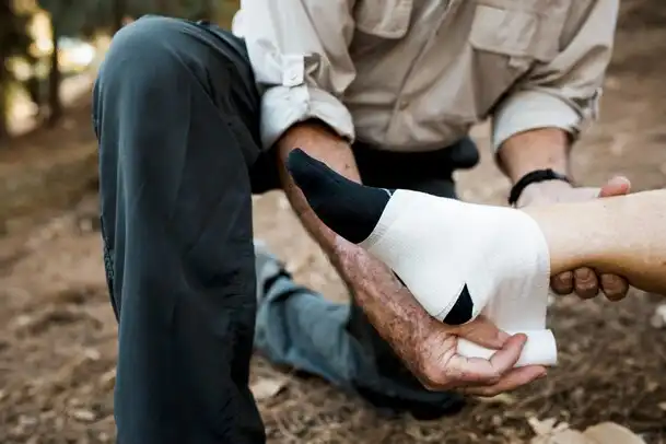 Assistance in case of injuries: man tending to his partner's foot